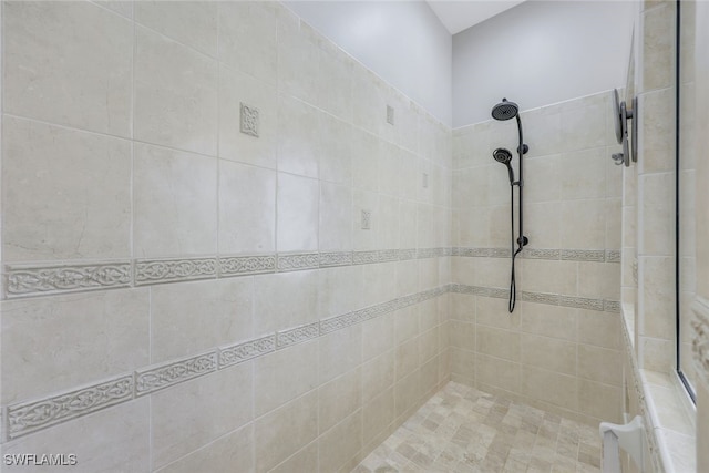 bathroom with a tile shower