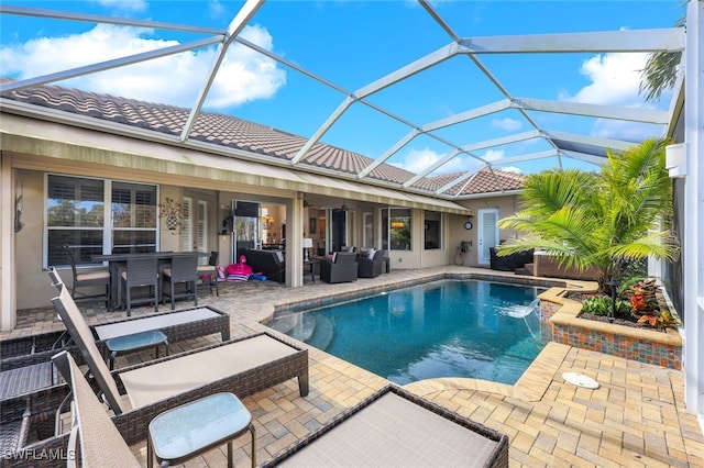 view of swimming pool with a lanai, a patio area, pool water feature, and an outdoor hangout area