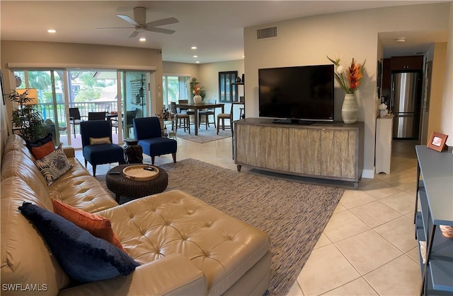 living room with ceiling fan and light tile patterned floors