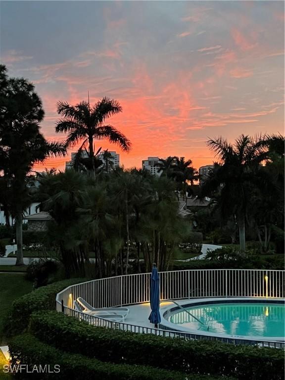 view of pool at dusk