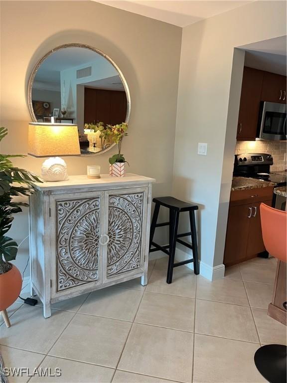 hallway featuring light tile patterned floors