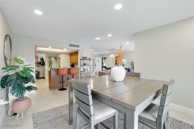 dining area featuring light tile patterned flooring