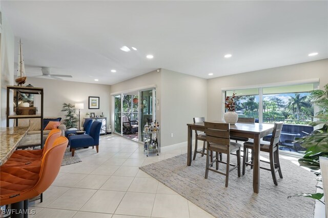 tiled dining space with ceiling fan