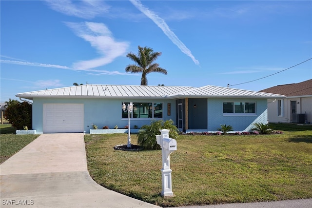 single story home featuring cooling unit, a garage, and a front lawn