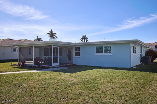 view of front of house with central AC, a front lawn, and a sunroom