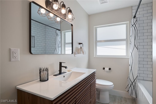 full bathroom with vanity, wood-type flooring, shower / bathtub combination with curtain, and toilet