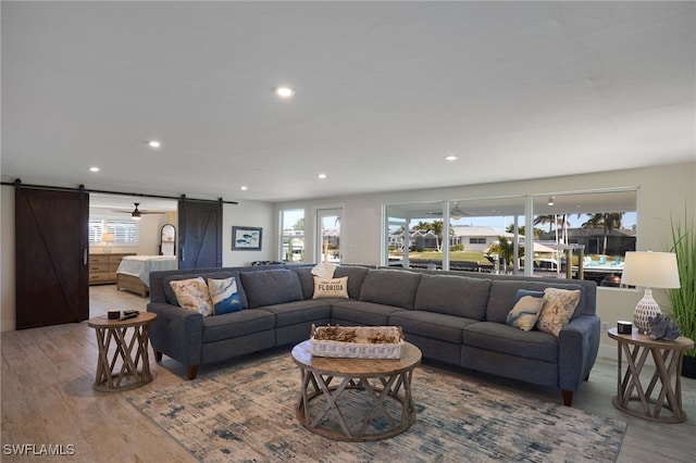 living room featuring hardwood / wood-style flooring and a barn door