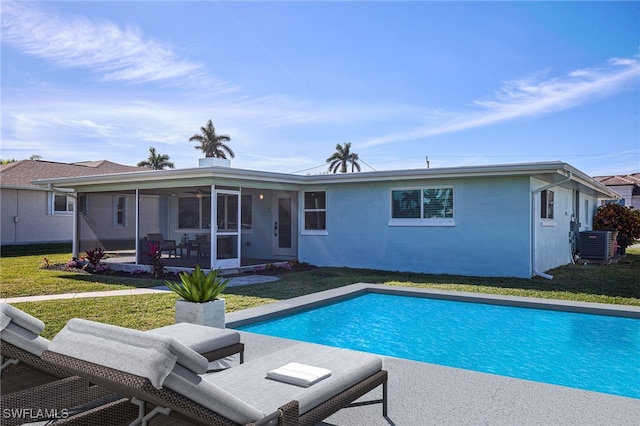 back of property featuring central AC unit, a yard, and a sunroom