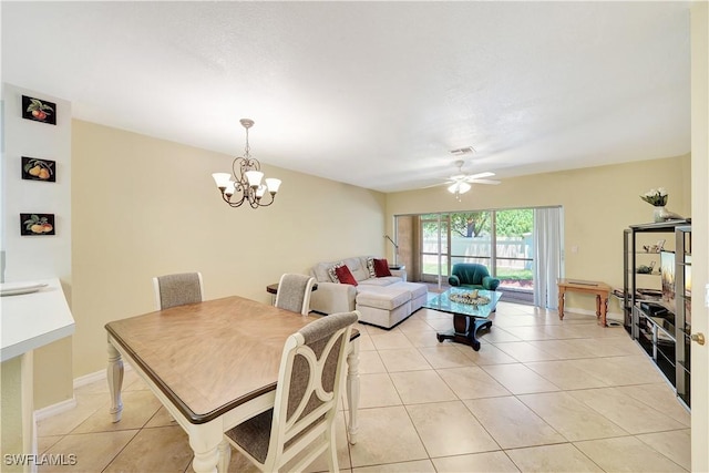 dining space featuring light tile patterned floors and ceiling fan with notable chandelier