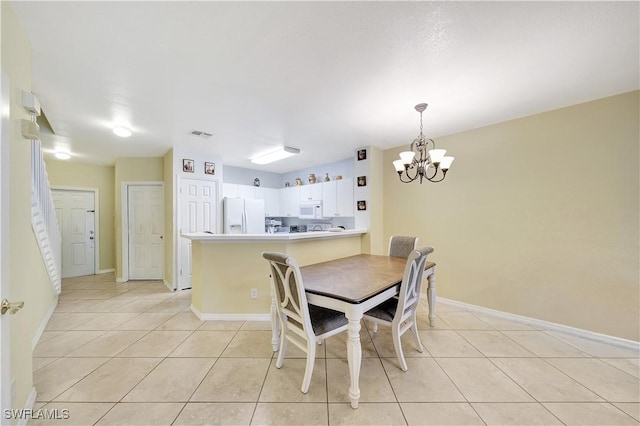 dining room with light tile patterned flooring and a chandelier