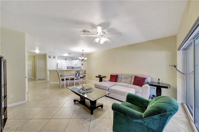 tiled living room with ceiling fan with notable chandelier