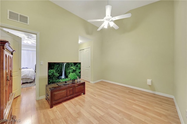 living room with light wood-type flooring and vaulted ceiling