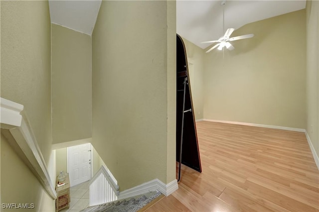 interior space featuring ceiling fan, wood-type flooring, and lofted ceiling