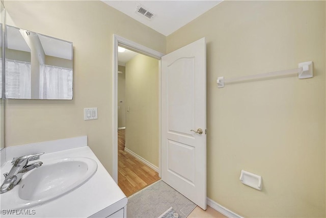 bathroom featuring vanity and wood-type flooring