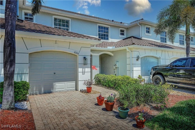 mediterranean / spanish-style home with a garage