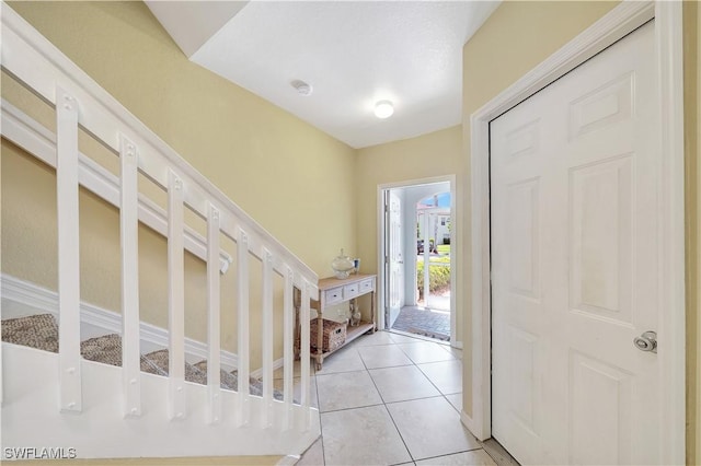 foyer entrance with light tile patterned floors