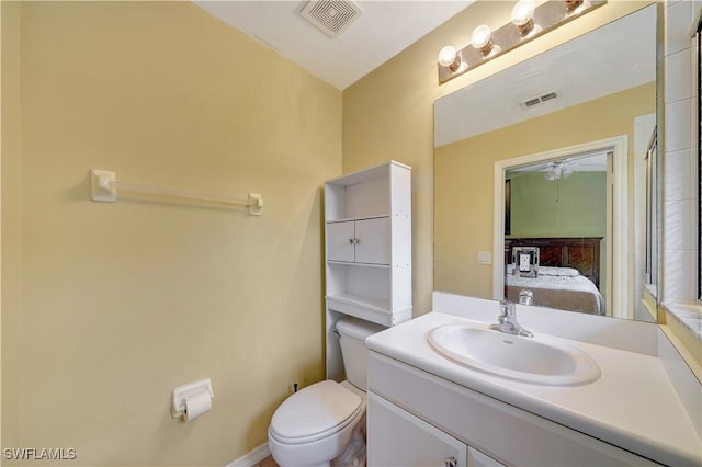 bathroom featuring ceiling fan, vanity, and toilet