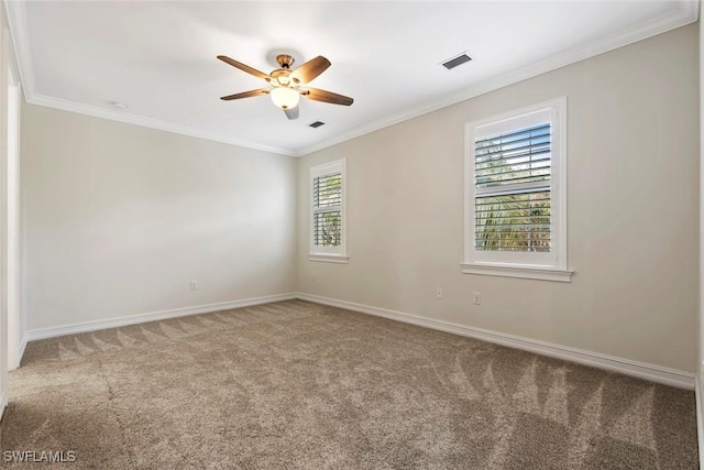 carpeted spare room with plenty of natural light, ornamental molding, and ceiling fan