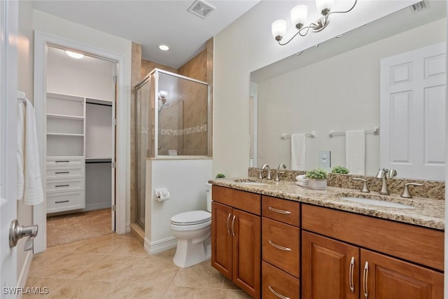 bathroom with tile patterned flooring, vanity, toilet, and a shower with shower door