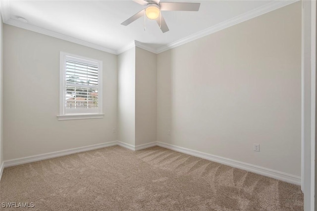 carpeted empty room featuring ceiling fan and ornamental molding