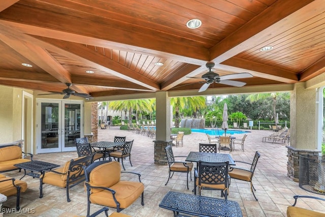 view of patio / terrace featuring a fenced in pool, ceiling fan, and french doors