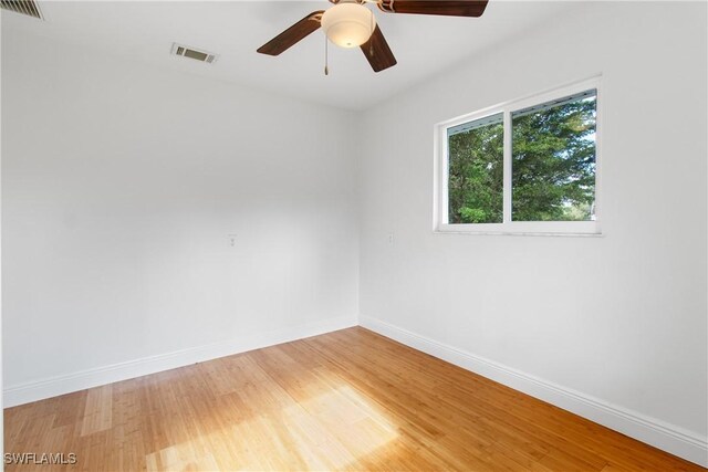 empty room with hardwood / wood-style flooring and ceiling fan