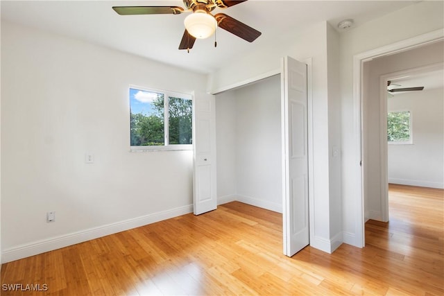 unfurnished bedroom with ceiling fan, a closet, and light hardwood / wood-style flooring