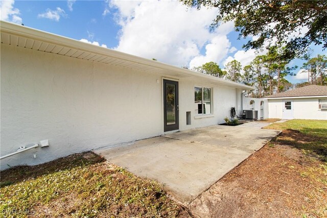 exterior space with central AC unit and a patio area