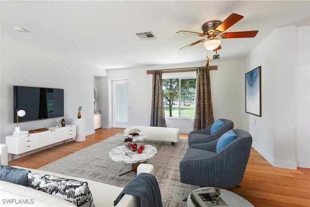 living room with ceiling fan and light hardwood / wood-style floors