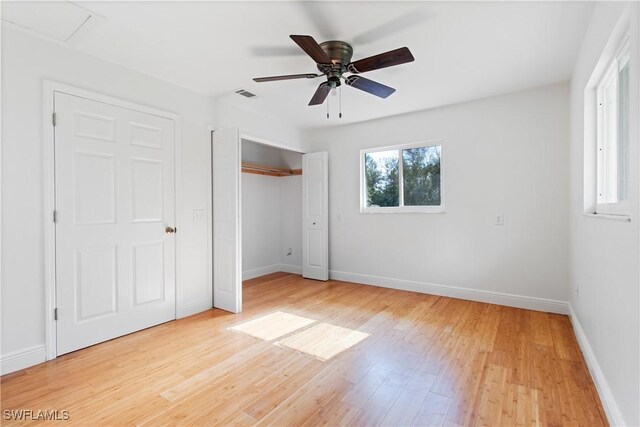 unfurnished bedroom featuring ceiling fan, a closet, and light hardwood / wood-style floors