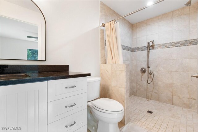 bathroom with vanity, curtained shower, and toilet