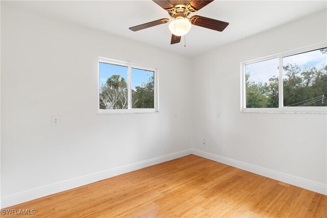 spare room featuring ceiling fan and hardwood / wood-style floors