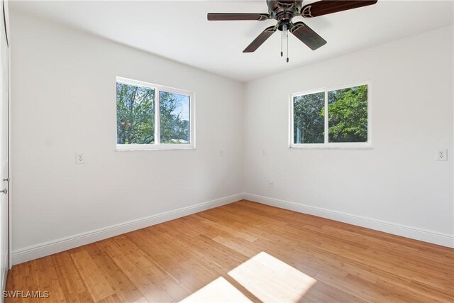 spare room featuring ceiling fan and hardwood / wood-style floors