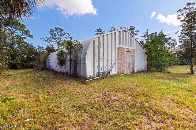 view of outbuilding with a lawn