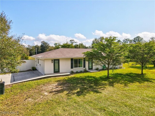 single story home with a front lawn and a patio