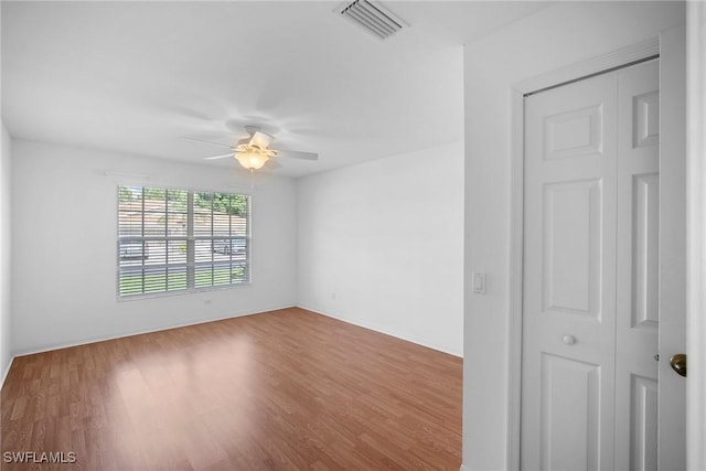 unfurnished room with ceiling fan and hardwood / wood-style flooring