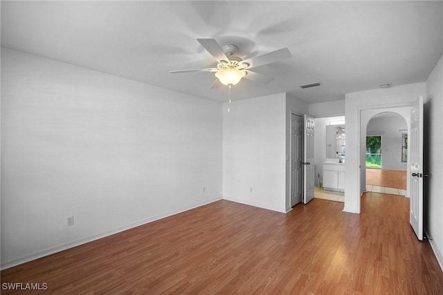 empty room featuring wood-type flooring and ceiling fan