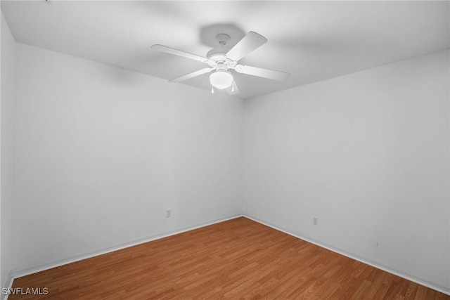 spare room with hardwood / wood-style floors and ceiling fan