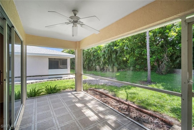 unfurnished sunroom featuring ceiling fan