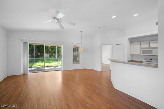 unfurnished living room featuring ceiling fan, light hardwood / wood-style floors, and vaulted ceiling