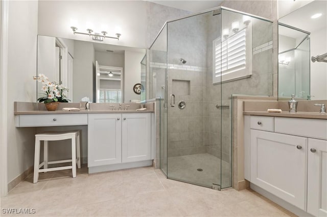 bathroom with tile patterned floors, an enclosed shower, and vanity