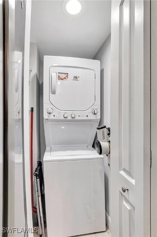 washroom featuring stacked washer and dryer