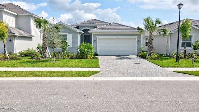 view of front facade with a garage and a front lawn