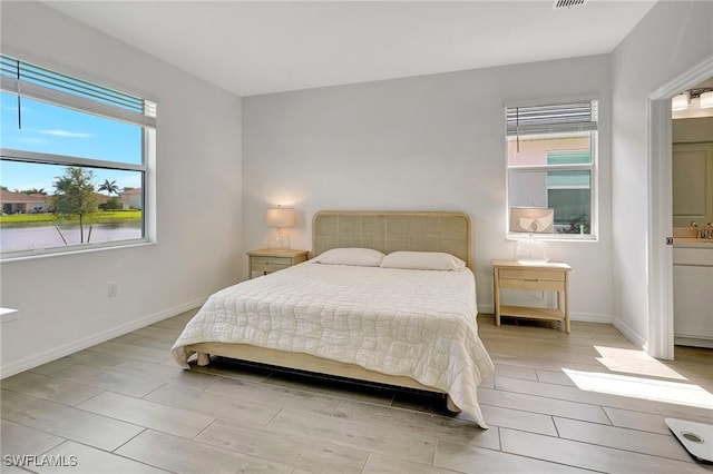 bedroom with multiple windows and ensuite bath