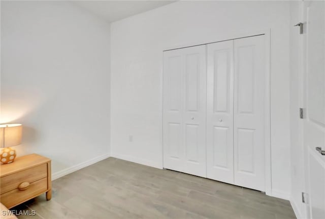 bedroom featuring light hardwood / wood-style floors and a closet