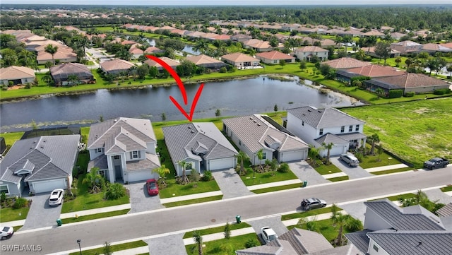 birds eye view of property featuring a water view