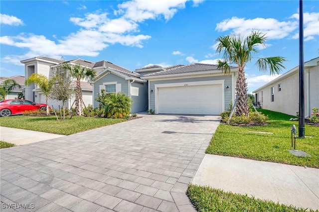 view of front of home featuring a garage and a front yard