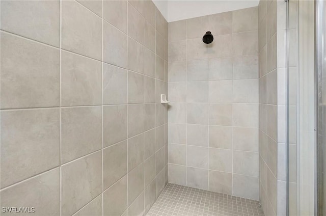 bathroom with tiled shower