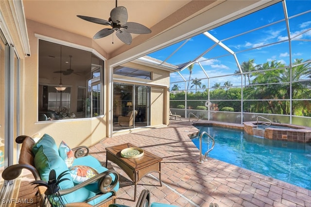 view of pool featuring a patio area, ceiling fan, glass enclosure, and an in ground hot tub