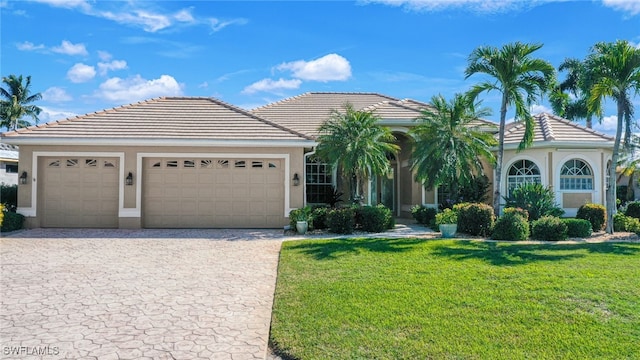 view of front of house with a garage and a front lawn